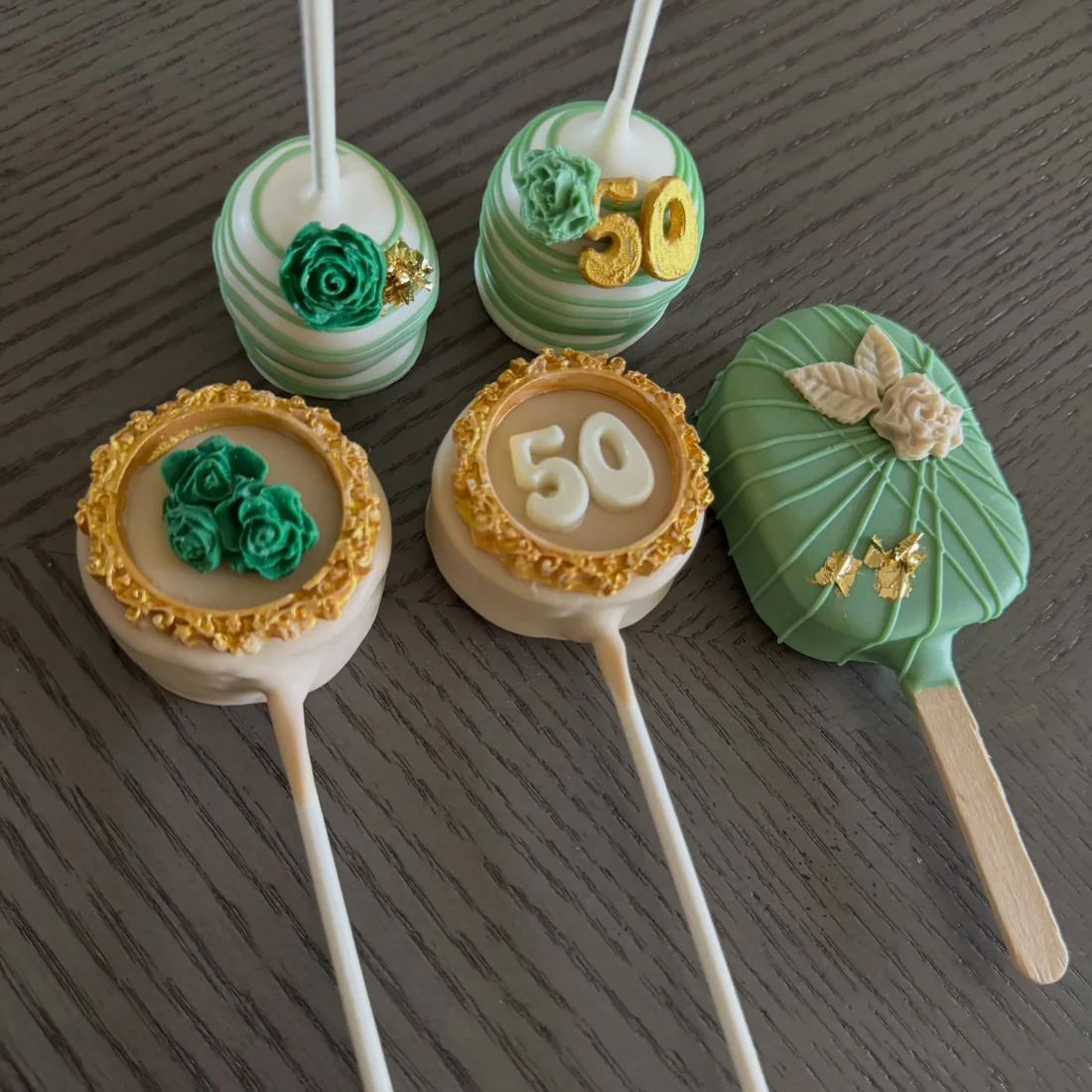 Set of 50th birthday cake pops in emerald green and gold