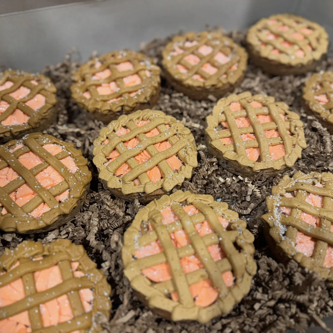 Tray of mini peach cookie pies with piped buttercream lattices
