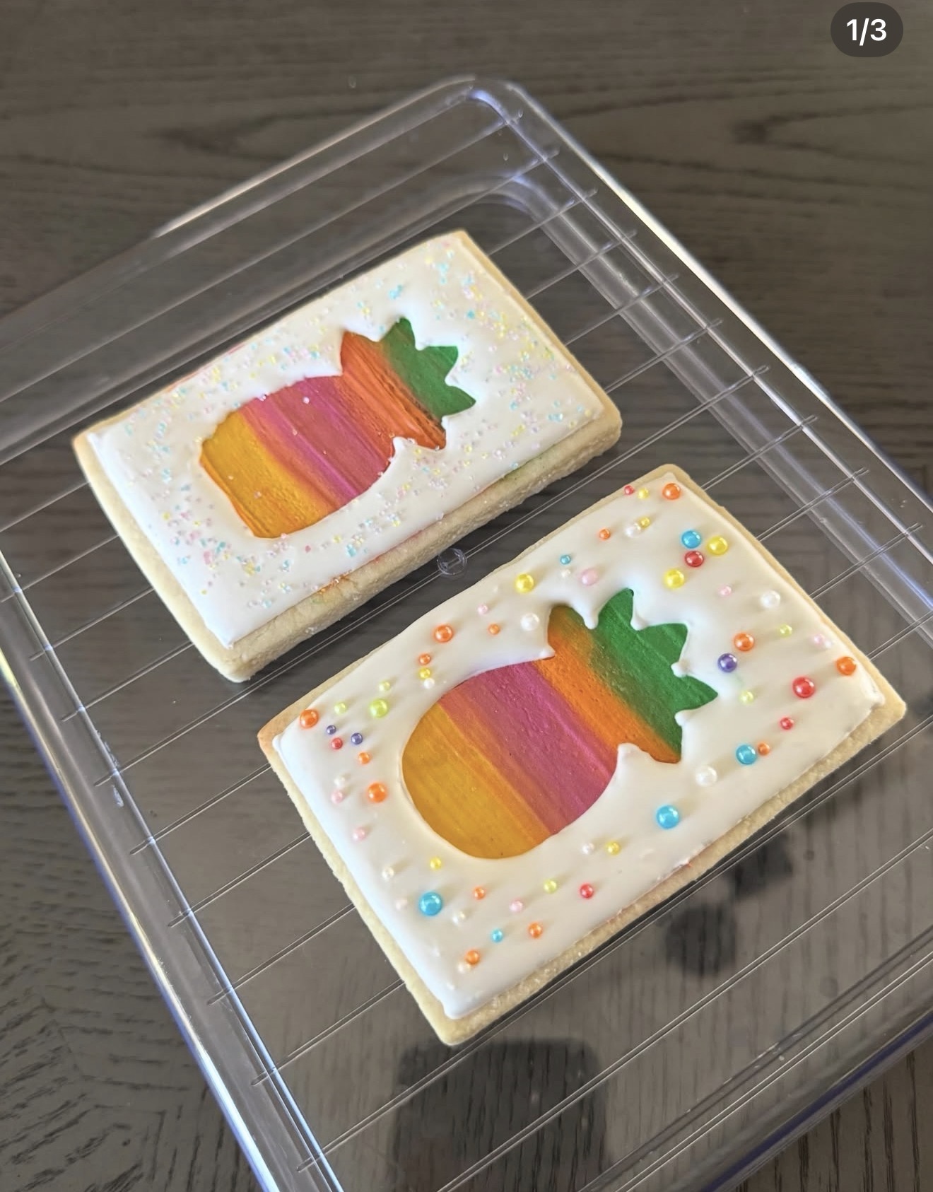 Rectangle sugar cookies with rainbow painted pineapple design and colorful sprinkle pearls